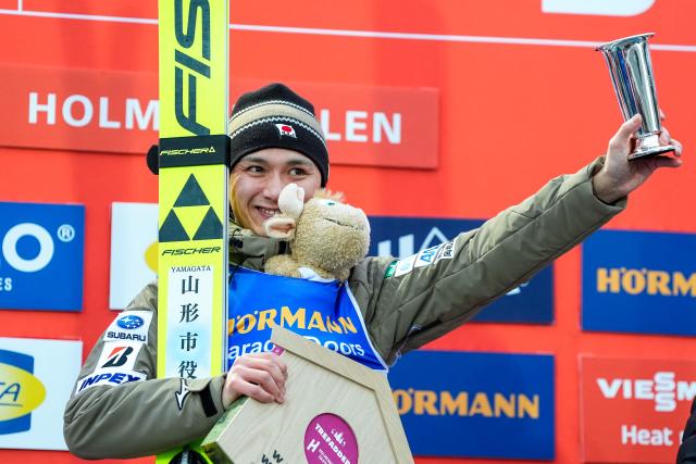 Winner Japan's Tomofumi Naito celebrates on the podium after the men's Individual Large Hill at the FIS Jumping World Cup in Holmenkollen, Oslo, Norway on March 15, 2026. (Photo by Terje Pedersen / NTB / AFP) / Norway OUT