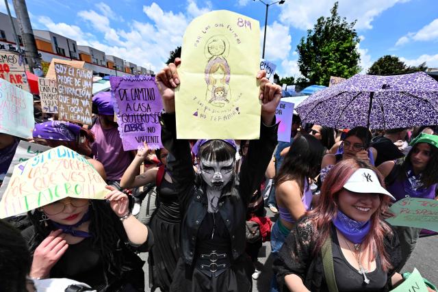 Women hold allusive signs during a march to commemorate the International Women's Day in Bogota on March 15, 2026. (Photo by Diana SANCHEZ / AFP)