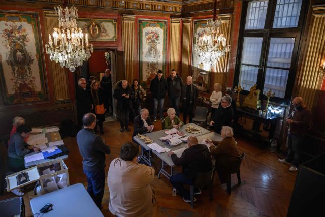 Officials process materials following the closing of voting during municipal elections at the city hall in Perpignan, south-western France, on March 15, 2026. (Photo by Ed JONES / AFP)