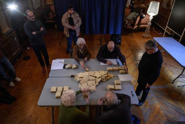 Officials process materials following the closing of voting during municipal elections at the city hall in Perpignan, south-western France, on March 15, 2026. (Photo by Ed JONES / AFP)