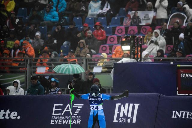 Russia’s Aleksey Bugaev celebrates as he crosses the finish line of the men ski slalom during the Milano Cortina 2026 Paralympic Winter Games on March 15, 2026 in Cortina d’Ampezzo. (Photo by JEFF PACHOUD / AFP)