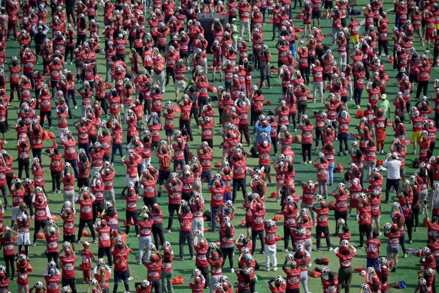 This aerial view shows some of the thousands of attendees to a world-class football clinic at the Zocalo square in Mexico City on March 15, 2026, aimed at setting a new Guinness World Record. (Photo by Alfredo ESTRELLA / AFP)