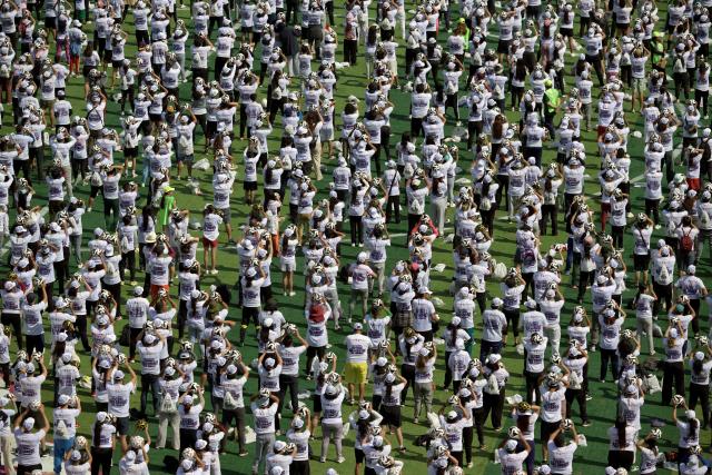 This aerial view shows some of the thousands of attendees to a world-class football clinic at the Zocalo square in Mexico City on March 15, 2026, aimed at setting a new Guinness World Record. (Photo by Alfredo ESTRELLA / AFP)