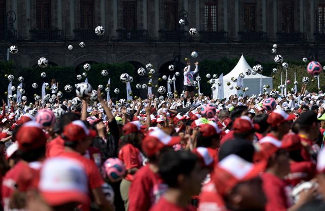 Hundreds of people take part in a world-class football clinic at the Zocalo square in Mexico City on March 15, 2026, aimed at setting a new Guinness World Record. (Photo by Alfredo ESTRELLA / AFP)
