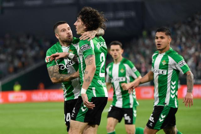 Real Betis' Spanish defender #02 Hector Bellerin (2L) celebrates scoring his team's first goal during the Spanish league football match between Real Betis and RC Celta de Vigo at Benito Villamarin Stadium in Seville on March 15, 2026. (Photo by CRISTINA QUICLER / AFP)