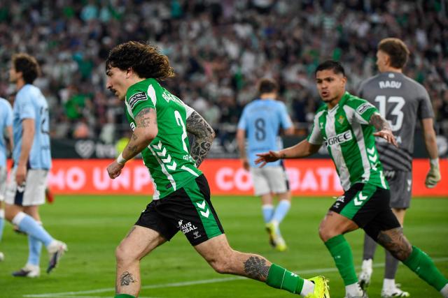 Real Betis' Spanish defender #02 Hector Bellerin (L) celebrates scoring his team's first goal during the Spanish league football match between Real Betis and RC Celta de Vigo at Benito Villamarin Stadium in Seville on March 15, 2026. (Photo by CRISTINA QUICLER / AFP)