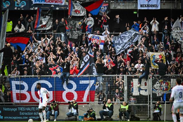 Lyon’s supporters cheer from the stands during the French L1 football match between Le Havre AC and Olympique Lyonnais (OL) at the Stade Oceane in Le Havre, north-western France, on March 15, 2026. (Photo by LOU BENOIST / AFP)