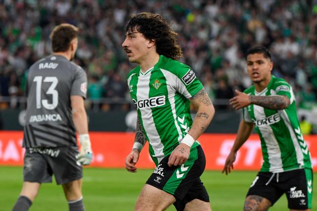 Real Betis' Spanish defender #02 Hector Bellerin (C) celebrates scoring his team's first goal during the Spanish league football match between Real Betis and RC Celta de Vigo at Benito Villamarin Stadium in Seville on March 15, 2026. (Photo by CRISTINA QUICLER / AFP)
