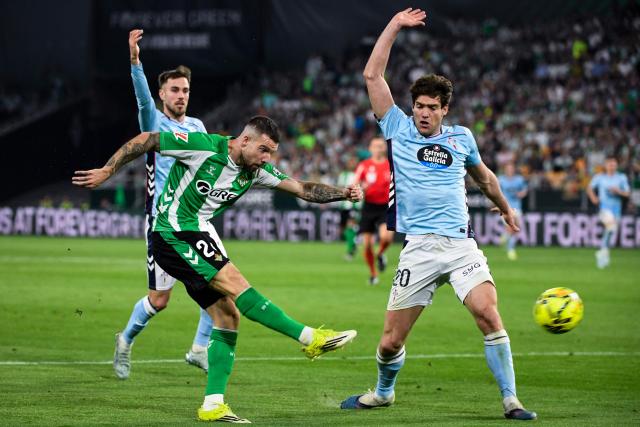 Real Betis' Spanish defender #24 Aitor Ruibal Garcia (L) shoots during the Spanish league football match between Real Betis and RC Celta de Vigo at Benito Villamarin Stadium in Seville on March 15, 2026. (Photo by CRISTINA QUICLER / AFP)