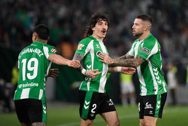 Real Betis' Spanish defender #02 Hector Bellerin (C) celebrates scoring his team's first goal during the Spanish league football match between Real Betis and RC Celta de Vigo at Benito Villamarin Stadium in Seville on March 15, 2026. (Photo by CRISTINA QUICLER / AFP)