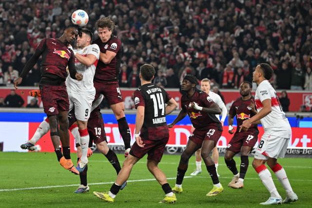 (L-R) Leipzig's French defender #23 Castello Lukeba, Stuttgart's Bosnian forward #09 Ermedin Demirovic and Leipzig's Hungarian defender #04 Willi Orban jump to head the ball during the German first division Bundesliga football match between VfB Stuttgart and RB Leipzig in Stuttgart, southern Germany, on March 15, 2026. (Photo by THOMAS KIENZLE / AFP) / DFL REGULATIONS PROHIBIT ANY USE OF PHOTOGRAPHS AS IMAGE SEQUENCES AND/OR QUASI-VIDEO