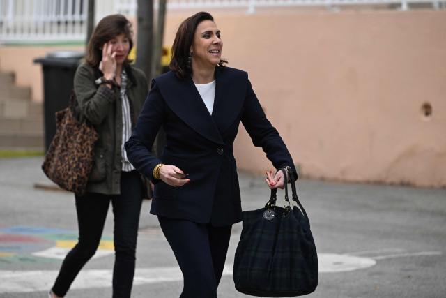 Toulon’s far-right Rassemblement National (RN) party mayoral candidate, Laure Lavalette (C) arrives to cast her ballot during the first round of France's 2026 municipal elections in Toulon, southern France, on March 15, 2026. (Photo by Miguel MEDINA / AFP)