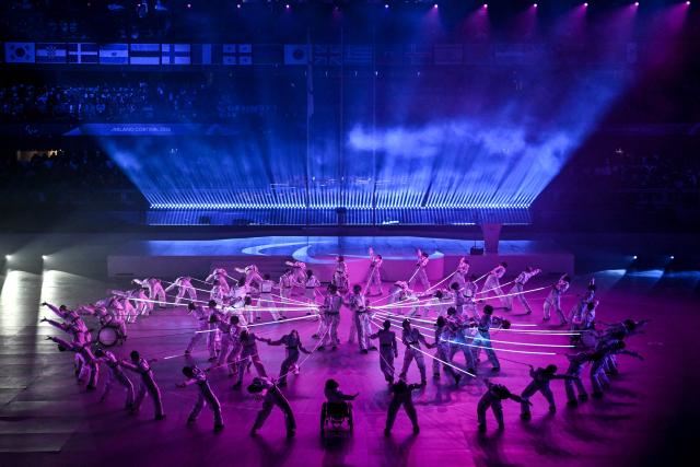 Performers take part in the Milano Cortina 2026 Winter Paralympic Games closing ceremony at the Olympic Ice Stadium in Cortina d'Ampezzo, on March 15, 2026. (Photo by Jeff PACHOUD / AFP)