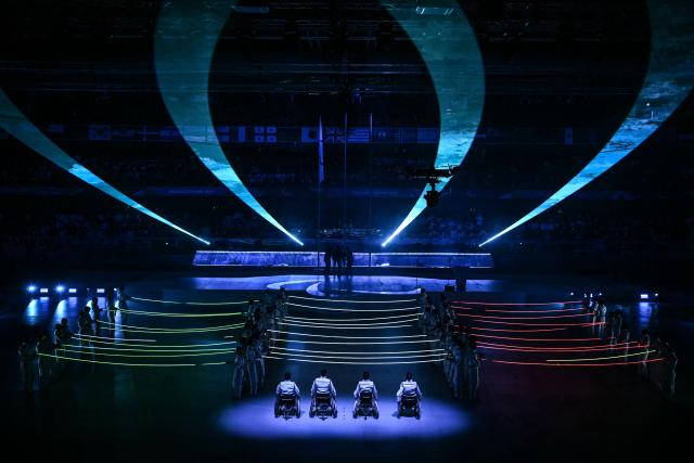 Performers take part in the Milano Cortina 2026 Winter Paralympic Games closing ceremony at the Olympic Ice Stadium in Cortina d'Ampezzo, on March 15, 2026. (Photo by Jeff PACHOUD / AFP)