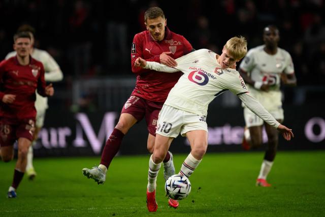 Rennes' French midfielder #21 Valentin Rongier (L) fights for the ball with Lille's Icelandic midfielder #10 Hakon Arnar Haraldsson during the French L1 football match between Stade Rennais and Losc Lille at the Roazhon Park stadium in Rennes, western France on March 15, 2026. (Photo by Loic VENANCE / AFP)