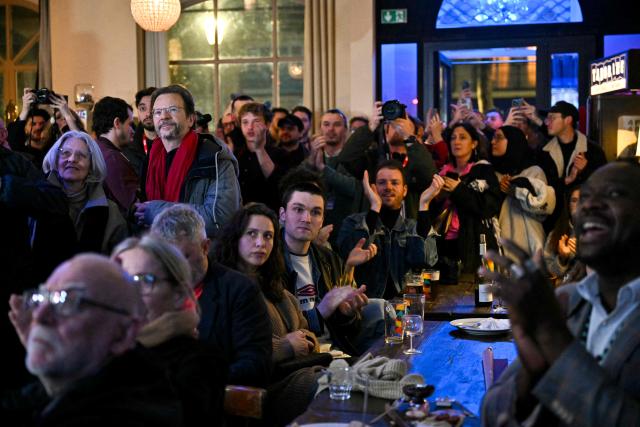 Supporters of Left-wing La France Insoumise (LFI) mayoral candidate in Paris, Sophia Chikirou react as first results are announced following the first round of France's 2026 municipal elections in Paris on March 15, 2026. (Photo by Martin LELIEVRE / AFP)