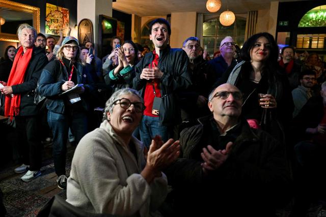 Supporters of Left-wing La France Insoumise (LFI) mayoral candidate in Paris, Sophia Chikirou react as first results are announced following the first round of France's 2026 municipal elections in Paris on March 15, 2026. (Photo by Martin LELIEVRE / AFP)