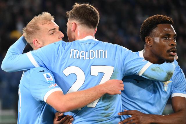 Lazio's Danish forward #18 Gustav Isaksen (L) celebrates with teammates after scoring Lazio's first goal during the Italian Serie A football match between Lazio and AC Milan at the Olympic Stadium in Rome on March 15, 2026. (Photo by Alberto PIZZOLI / AFP)