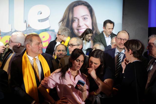 Supporters react as they look at a smartphone following the announcement of results of Far-right Reconquete! party mayoral candidate in Paris, Sarah Knafo in the first round of France's 2026 municipal elections in Paris on March 15, 2026. (Photo by Ludovic MARIN / AFP)
