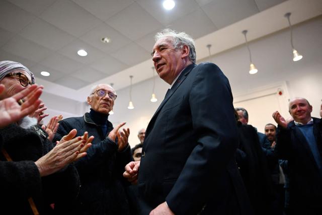 Incumbent mayor of Pau and centrist MoDem party candidate for re-election Francois Bayrou is applauded following the results of the first round of France's 2026 municipal elections in Pau, southwestern France, on March 15, 2026. Bayrou announced on Sunday that he was leading in the first round of the local elections in Pau, where he has been mayor since 2014. (Photo by GAIZKA IROZ / AFP)