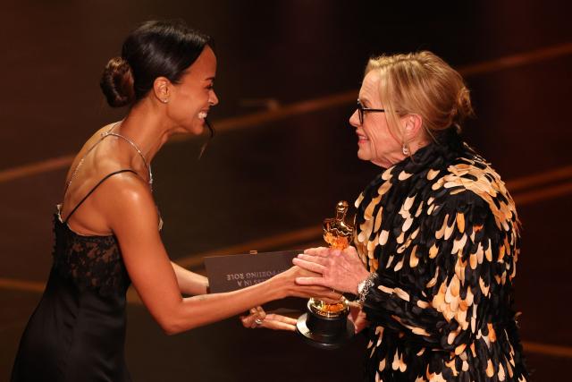US actress Zoe Saldana gives US actress Amy Madigan the Oscar for Best Actress in a Supporting Role for "Weapons" onstage during the 98th Annual Academy Awards at the Dolby Theatre in Hollywood, California on March 15, 2026. (Photo by Patrick T. Fallon / AFP)