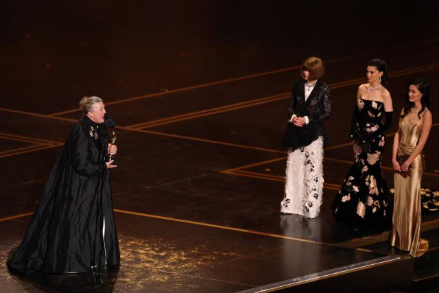 US costume designer Kate Hawley (L) holds her Oscar for Best Costume Design for "Frankenstein" onstage during the 98th Annual Academy Awards at the Dolby Theatre in Hollywood, California on March 15, 2026. (Photo by Patrick T. Fallon / AFP)