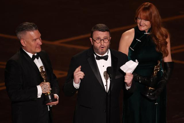 Hair and make-up artists (L/R) Jordan Samuel, Mike Hill and Cliona Furey speak onstage after winning the Oscar for Best Makeup and Hairstyling for "Frankenstein" during the 98th Annual Academy Awards at the Dolby Theatre in Hollywood, California on March 15, 2026. (Photo by Patrick T. Fallon / AFP)