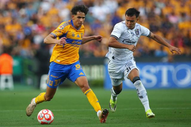 Tigres' defender #33 Rafael Guerrero and Queretaro's forward #31 Ali Avila fight for the ball during the Liga MX Clausura football match between Tigres and Queretaro at the University Stadium (UANL) in San Nicolas de los Garza, Mexico, on March 15, 2026. (Photo by Julio Cesar AGUILAR / AFP)