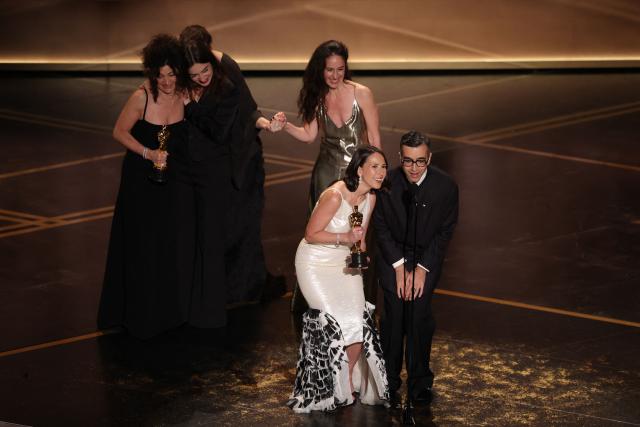 US curator Natalie Musteata and US filmmaker Alexandre Singh accept the Oscar for Best Live Action Short Film for "Two People Exchanging Saliva" onstage during the 98th Annual Academy Awards at the Dolby Theatre in Hollywood, California on March 15, 2026. (Photo by Patrick T. Fallon / AFP)