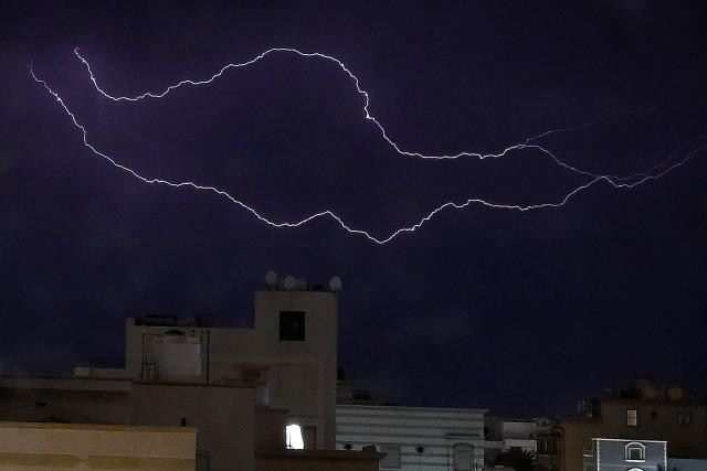 Lightning strikes in the sky over Kuwait City during a thunderstorm on March 16, 2026. (Photo by YASSER AL-ZAYYAT / AFP)