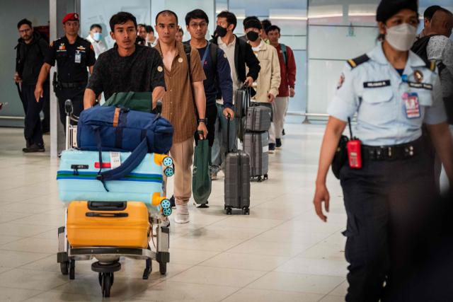 Thai crew members of the bulk carrier Mayuree Naree arrive at Suvarnabhumi International Airport after a flight from Oman, in Bangkok on March 16, 2026. Iran's Revolutionary Guards said on March 11 they had struck the Thai-registered Mayuree Naree, as well as a Liberia-flagged vessel, in the Strait of Hormuz because the ships had ignored "warnings". (Photo by chanakarn LAOSARAKHAM / AFP)
