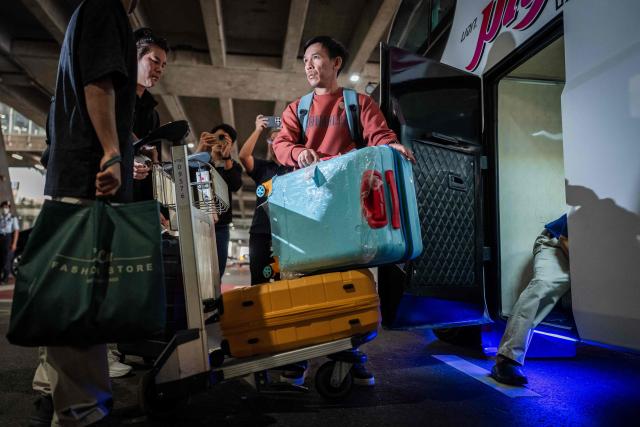 A Thai crew member of the bulk carrier Mayuree Naree arrives at Suvarnabhumi International Airport after a flight from Oman, in Bangkok on March 16, 2026. Iran's Revolutionary Guards said on March 11 they had struck the Thai-registered Mayuree Naree, as well as a Liberia-flagged vessel, in the Strait of Hormuz because the ships had ignored "warnings". (Photo by Chanakarn Laosarakham / AFP)