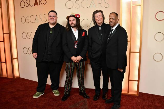 (L-R) Australian singer-songwriter Judah Kelly and guest, US singer and guitarist Chris Smither and US singer Mike Yung attend the 98th Annual Academy Awards at the Dolby Theatre in Hollywood, California on March 15, 2026. (Photo by Frederic J. Brown / AFP)
