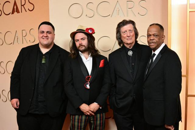 (L-R) Australian singer-songwriter Judah Kelly and guest, US singer and guitarist Chris Smither and US singer Mike Yung attend the 98th Annual Academy Awards at the Dolby Theatre in Hollywood, California on March 15, 2026. (Photo by Frederic J. Brown / AFP)
