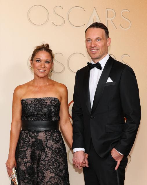 US visual effects supervisor Michael Ralla and a guest  attend the 98th Annual Academy Awards at the Dolby Theatre in Hollywood, California on March 15, 2026. (Photo by ANGELA WEISS / AFP)