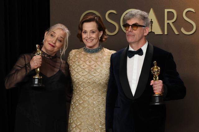 US actress and presenter Sigourney Weaver (C) stands with Canadian art director Tamara Deverell (L) and Canadian set decorator Shane Vieau (R) as they pose in the press room with the Oscar for Best Production Design for "Frankenstein" during the 98th Annual Academy Awards at the Dolby Theatre in Hollywood, California on March 15, 2026. (Photo by VALERIE MACON / AFP)