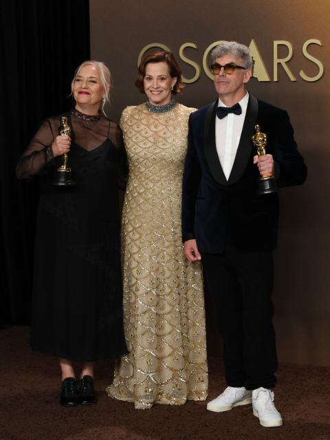 US actress and presenter Sigourney Weaver (C) stands with Canadian art director Tamara Deverell (L) and Canadian set decorator Shane Vieau (R) as they pose in the press room with the Oscar for Best Production Design for "Frankenstein" during the 98th Annual Academy Awards at the Dolby Theatre in Hollywood, California on March 15, 2026. (Photo by VALERIE MACON / AFP)