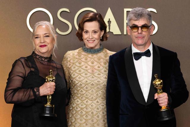 US actress and presenter Sigourney Weaver (C) stands with Canadian art director Tamara Deverell (L) and Canadian set decorator Shane Vieau (R) as they pose in the press room with the Oscar for Best Production Design for "Frankenstein" during the 98th Annual Academy Awards at the Dolby Theatre in Hollywood, California on March 15, 2026. (Photo by VALERIE MACON / AFP)
