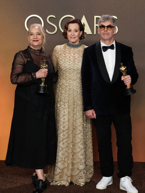US actress and presenter Sigourney Weaver (C) stands with Canadian art director Tamara Deverell (L) and Canadian set decorator Shane Vieau (R) as they pose in the press room with the Oscar for Best Production Design for "Frankenstein" during the 98th Annual Academy Awards at the Dolby Theatre in Hollywood, California on March 15, 2026. (Photo by VALERIE MACON / AFP)