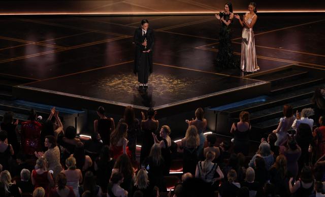 US cinematographer Autumn Durald Arkapaw accepts the award for Best Cinematography for "Sinners" as US actress Demi Moore (2R) applauds onstage during the 98th Annual Academy Awards at the Dolby Theatre in Hollywood, California on March 15, 2026. (Photo by Patrick T. Fallon / AFP)