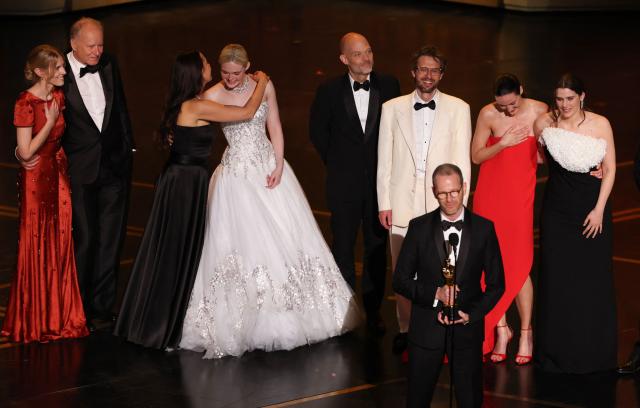 Danish-Norwegian film director and writer Joachim Trier accepts the award for Best International Feature Film for "Sentimental Value" alongside (back L/R) Norwegian producer Andrea Berentsen Ottmar, Swedish actor Stellan Skarsgard, Norwegian producer Maria Ekerhov, US actress Elle Fanning, Norwegian screenwriter Eskil Vogt, Norwegian actor Anders Danielsen Lie, Norwegian actress Renate Reinsve and Norwegian actress Inga Ibsdotter Lilleaas onstage during the 98th Annual Academy Awards at the Dolby Theatre in Hollywood, California on March 15, 2026. (Photo by Patrick T. Fallon / AFP)