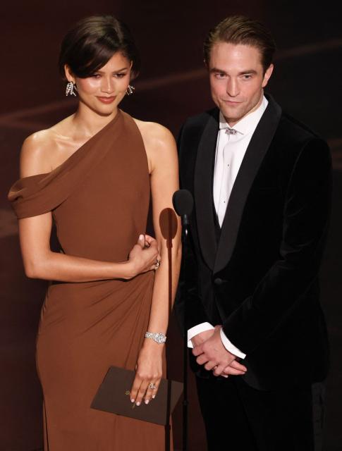 US actress and singer Zendaya and British actor Robert Pattinson present the award for Best Director onstage during the 98th Annual Academy Awards at the Dolby Theatre in Hollywood, California on March 15, 2026. (Photo by Patrick T. Fallon / AFP)
