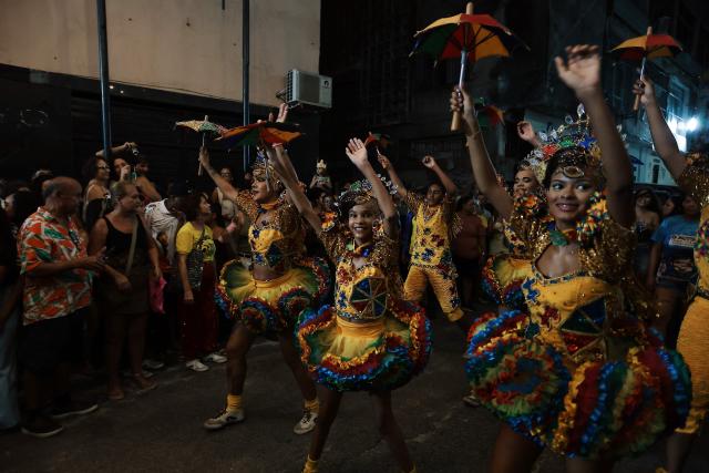 Dancers perform while people wait for the result of the nominations of the Brazilian film "O Agente Secreto" (The Secret Agent) in the 98th Annual Academy Awards (Oscars) in Recife, Brazil on March 15, 2026. Brazilians all over the country are gathered expecting the result of the nominations of the Brazilian film "O Agente Secreto" (The Secret Agent). (Photo by BRENDA ALCANTARA / AFP)