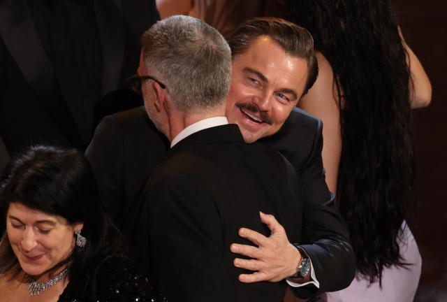 US filmmaker Paul Thomas Anderson and US actor Leonardo DiCaprio hug as they accept the award for Best Picture for "One Battle After Another" onstage during the 98th Annual Academy Awards at the Dolby Theatre in Hollywood, California on March 15, 2026. (Photo by Patrick T. Fallon / AFP)