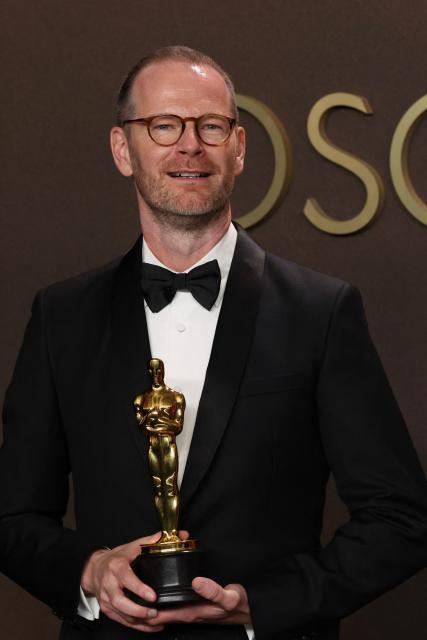 Danish-Norwegian film director and writer Joachim Trier poses in the press room with the Oscar for Best International Feature Film for "Sentimental Value" during the 98th Annual Academy Awards at the Dolby Theatre in Hollywood, California on March 15, 2026. (Photo by VALERIE MACON / AFP)