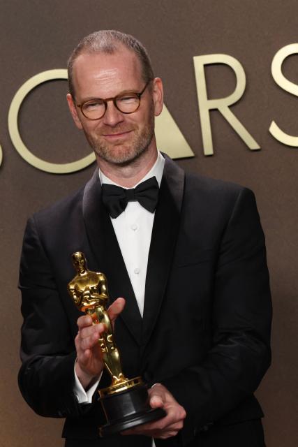 Danish-Norwegian film director and writer Joachim Trier poses in the press room with the Oscar for Best International Feature Film for "Sentimental Value" during the 98th Annual Academy Awards at the Dolby Theatre in Hollywood, California on March 15, 2026. (Photo by VALERIE MACON / AFP)