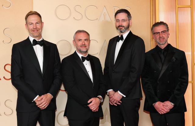 (L-R) Visual effects artists US' Ryan Tudhope, French-Canadian Nicolas Chevallier, Robert Harrington and guest attend the 98th Annual Academy Awards at the Dolby Theatre in Hollywood, California on March 15, 2026. (Photo by ANGELA WEISS / AFP)