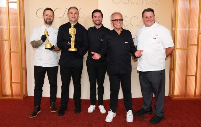 Austrian-US chef Wolfgang Puck (2R) and his team formed by (L-R) Garry Larduinat, Kamel Guechida, Byron Puck and Eric Klein attend the 98th Annual Academy Awards at the Dolby Theatre in Hollywood, California on March 15, 2026. (Photo by ANGELA WEISS / AFP)