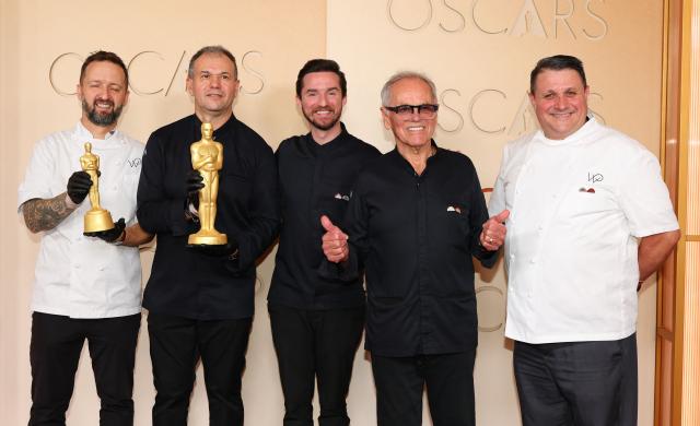 Austrian-US chef Wolfgang Puck (2R) and his team formed by (L-R) Garry Larduinat, Kamel Guechida, Byron Puck and Eric Klein attend the 98th Annual Academy Awards at the Dolby Theatre in Hollywood, California on March 15, 2026. (Photo by ANGELA WEISS / AFP)