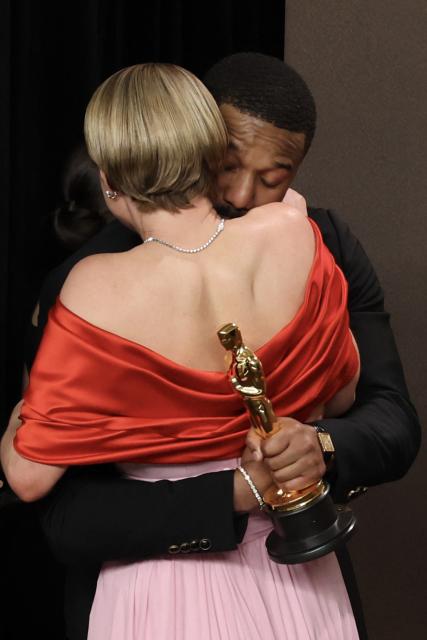 Irish actress Jessie Buckley, Oscar winner for Best Actress in a Leading Role for "Hamnet," hugs US actor Michael B. Jordan, Oscar winner for Best Actor in a Leading Role for "Sinners" in the press room during the 98th Annual Academy Awards at the Dolby Theatre in Hollywood, California on March 15, 2026. (Photo by VALERIE MACON / AFP)